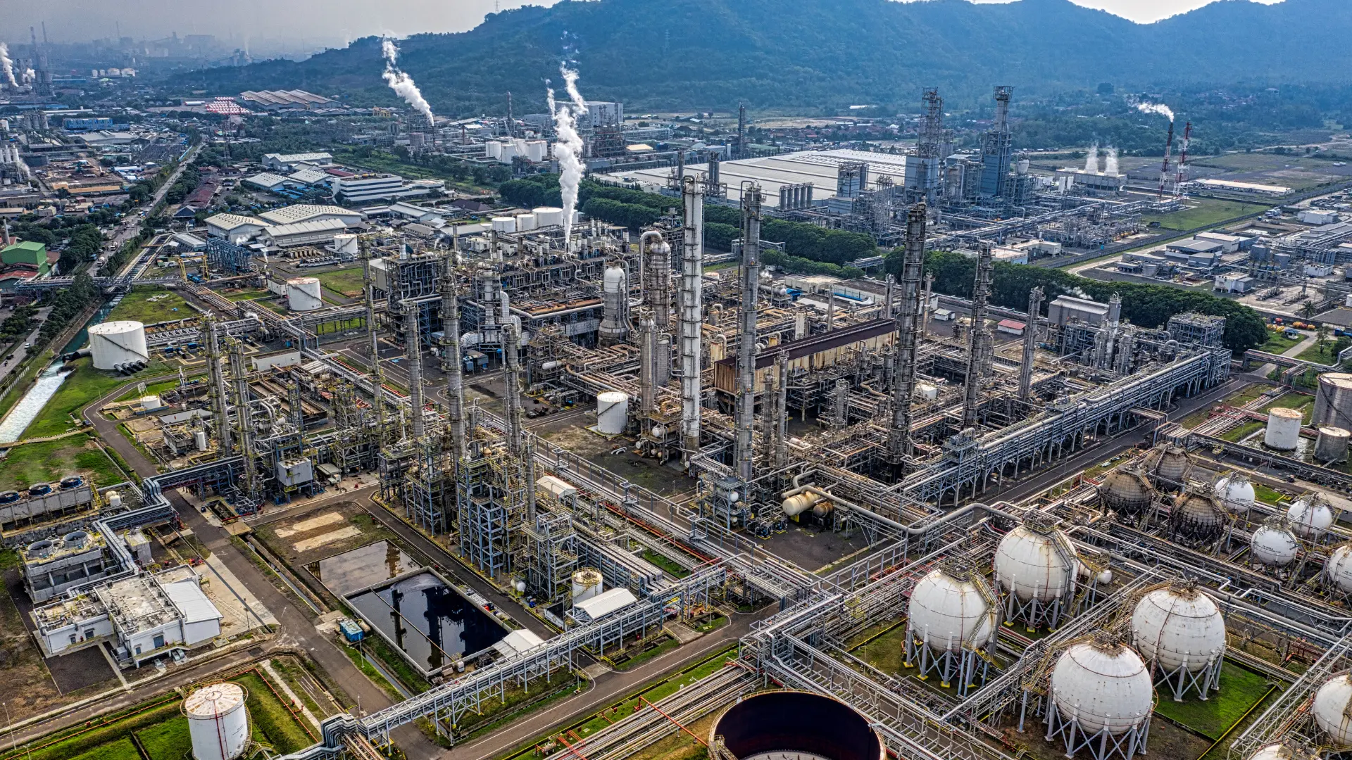 Oil and gas refinery plant with industrial processing units and piping systems